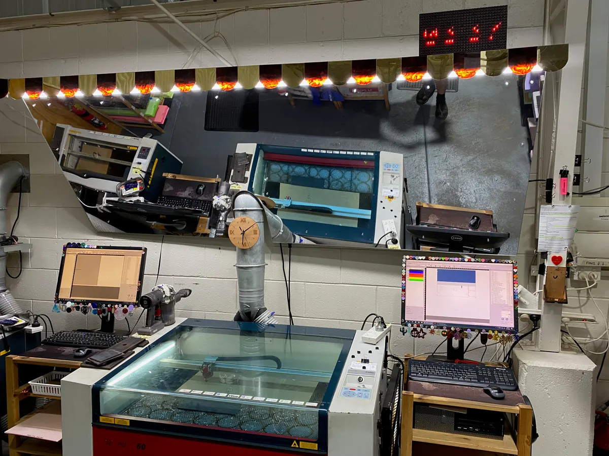 Finished LED ETA display mounted above the laser cutter workstation, showing a countdown time