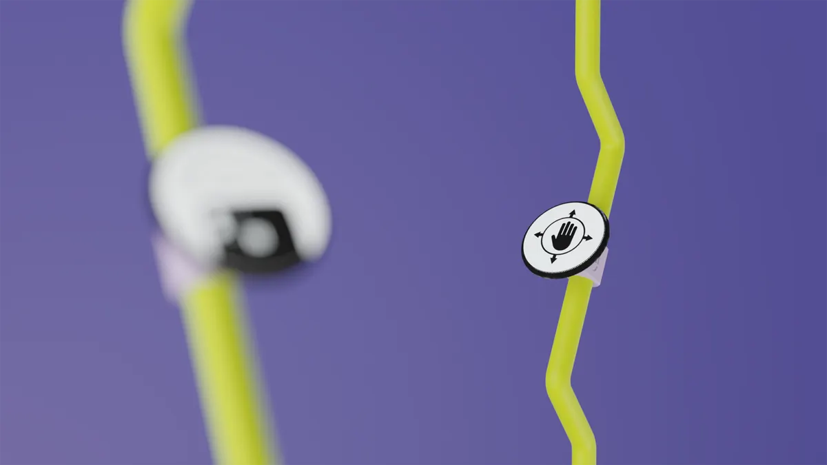 Close-up render of the PUK control handle on a kinked yellow mast, marked with a hand-and-arrows icon