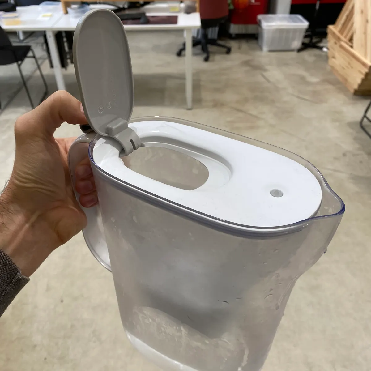 Inner lid opens to allow water input from the sink faucet into the first stage compartment. 