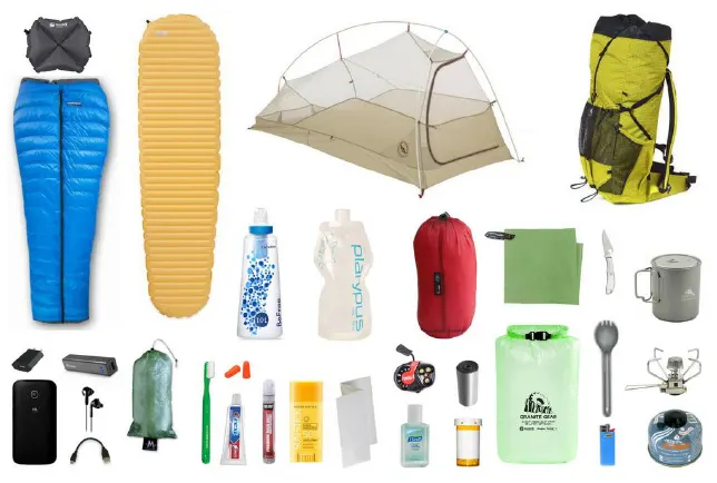 Flat lay of hiking gear including sleeping bag, mat, tent, backpack, water bottles and cooking kit