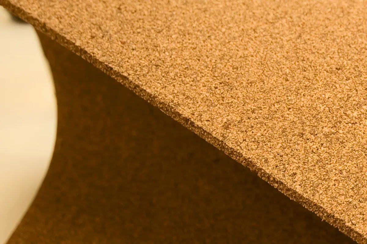 Close-up of a cork composite sheet showing its fine granular texture and cut edge