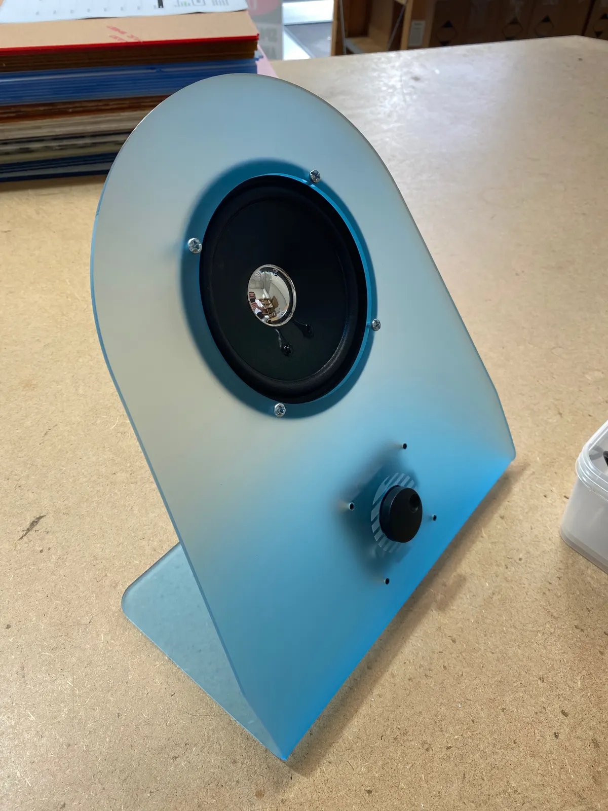 Assembled frosted blue acrylic speaker with driver and volume knob fitted
