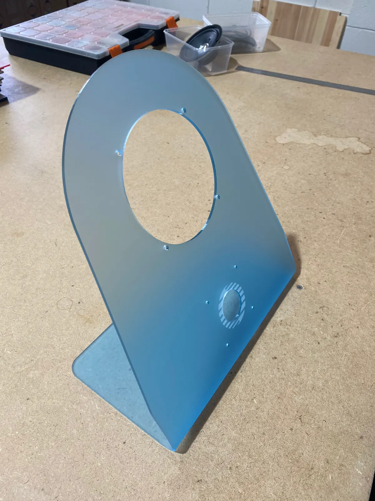Frosted blue acrylic speaker case, laser cut and heat bent, with holes for speaker and dial