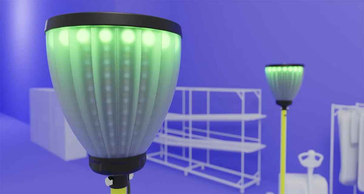 Close-up of the mast head's frosted dome glowing with green LEDs, a second flag blurred behind