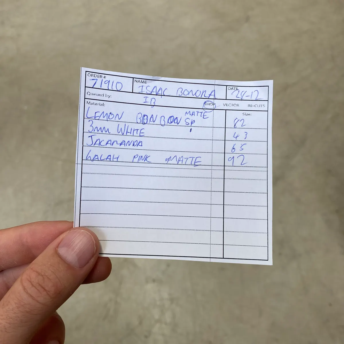 Handwritten paper template slip listing order number, materials and sizes, as used before Lazer.Grub