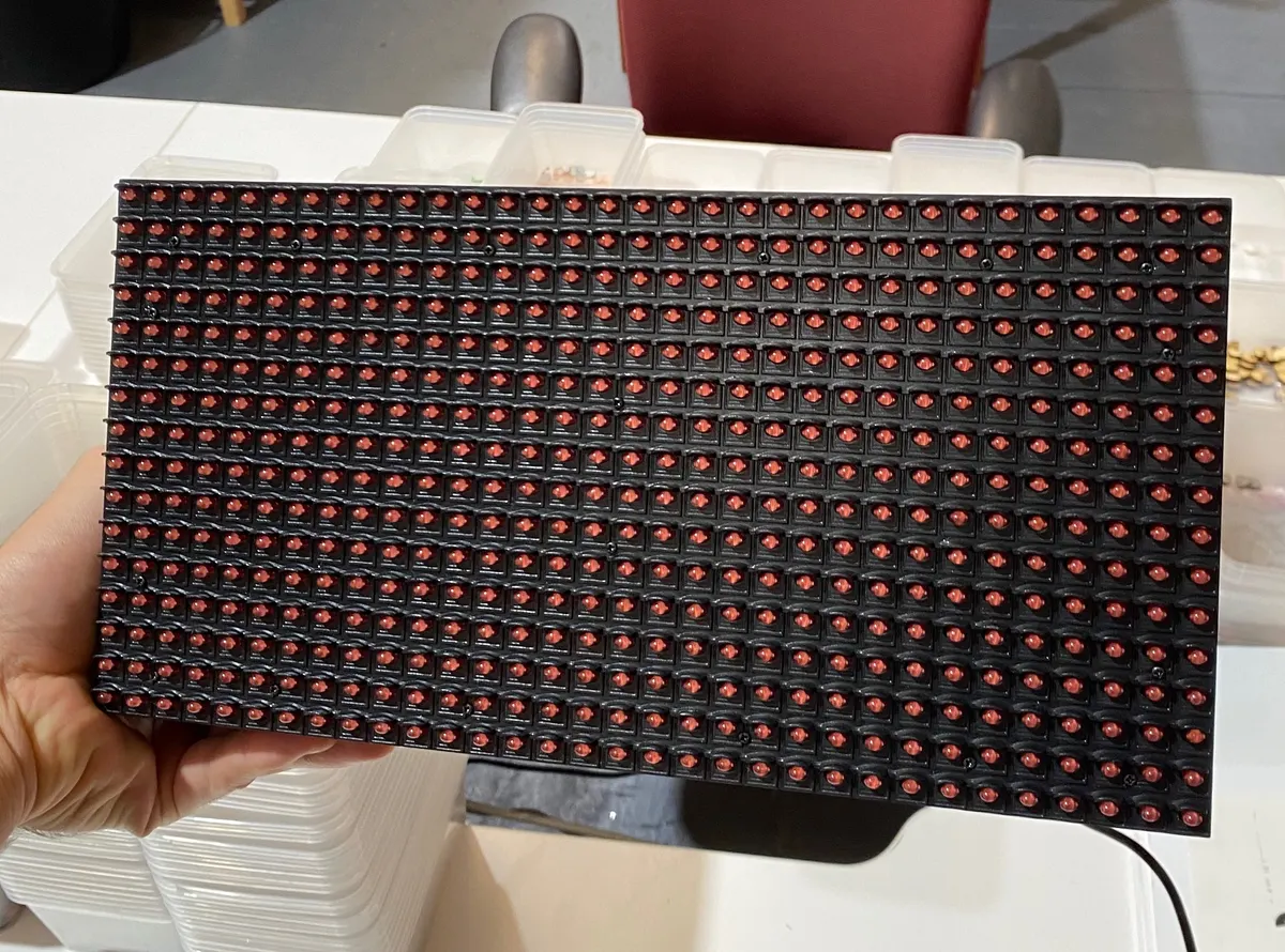 Hand holding the red LED matrix panel chosen for the ETA display