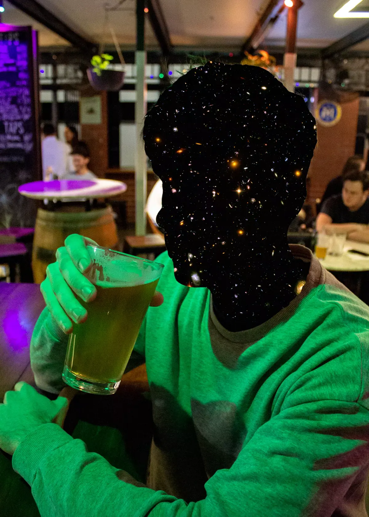 Campaign photo of a person holding a beer, their head replaced with a starry galaxy